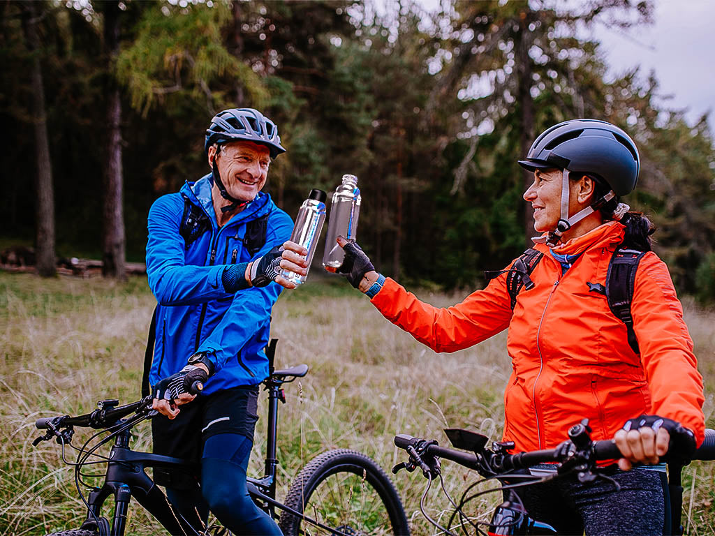 2 Mature Cyclists holding their Smartbottle