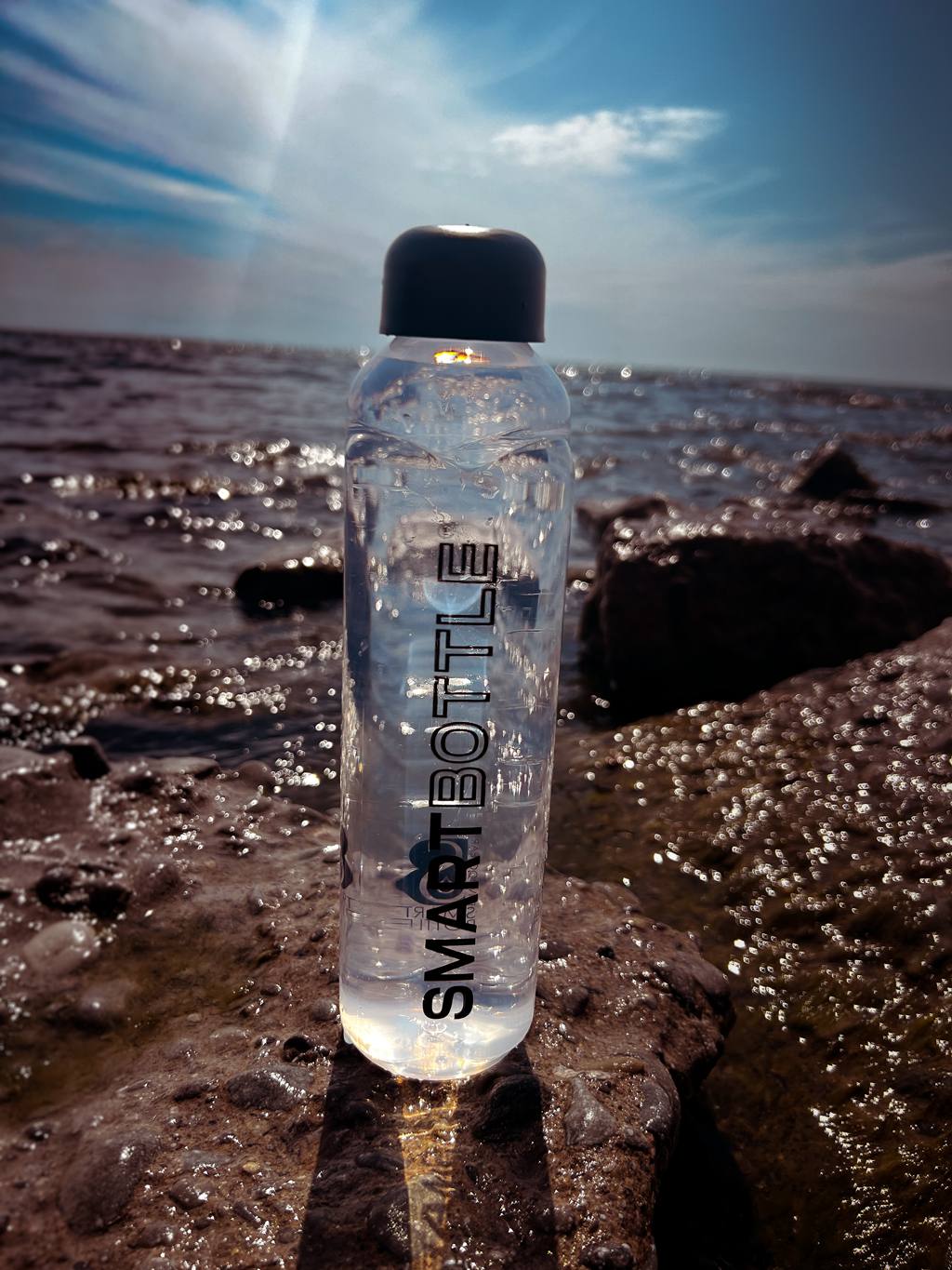 Smartbottle on top of the rock with lake background